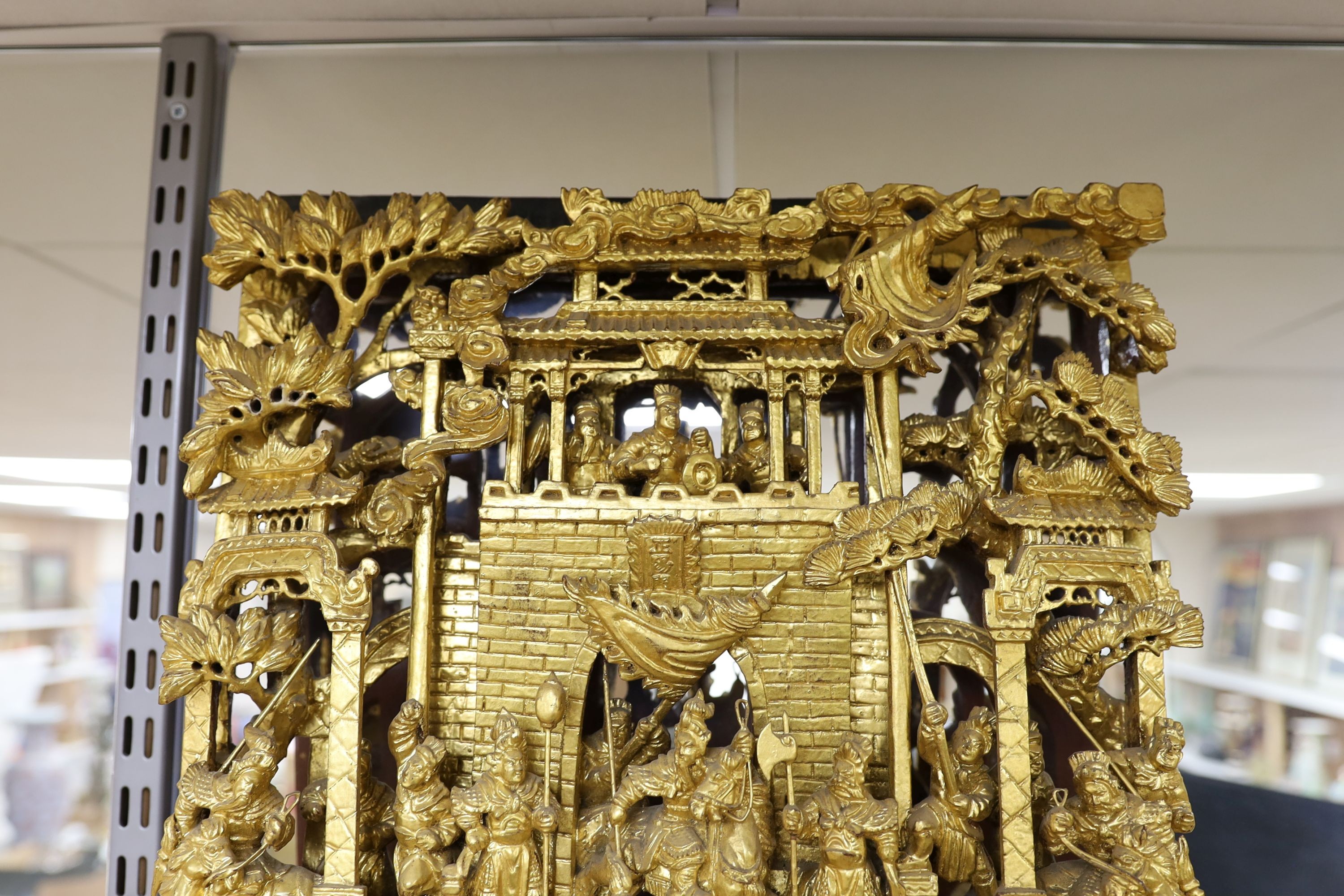 A large Chinese carved giltwood panel, 65 x 40cm